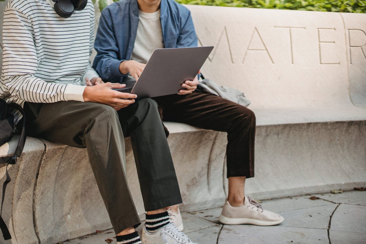 two man developing an app with one laoptop