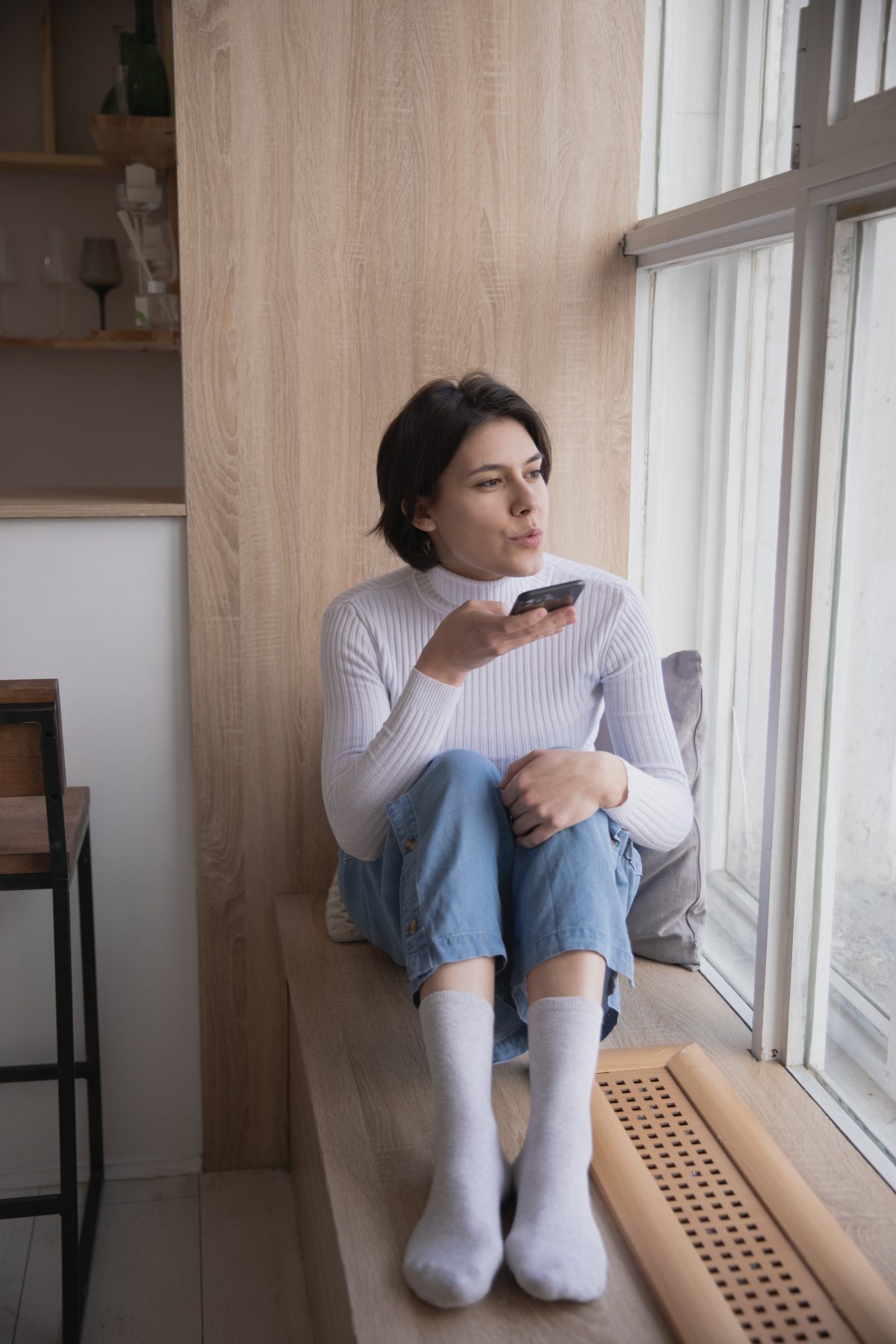 white woman recording an voice message in her phone app