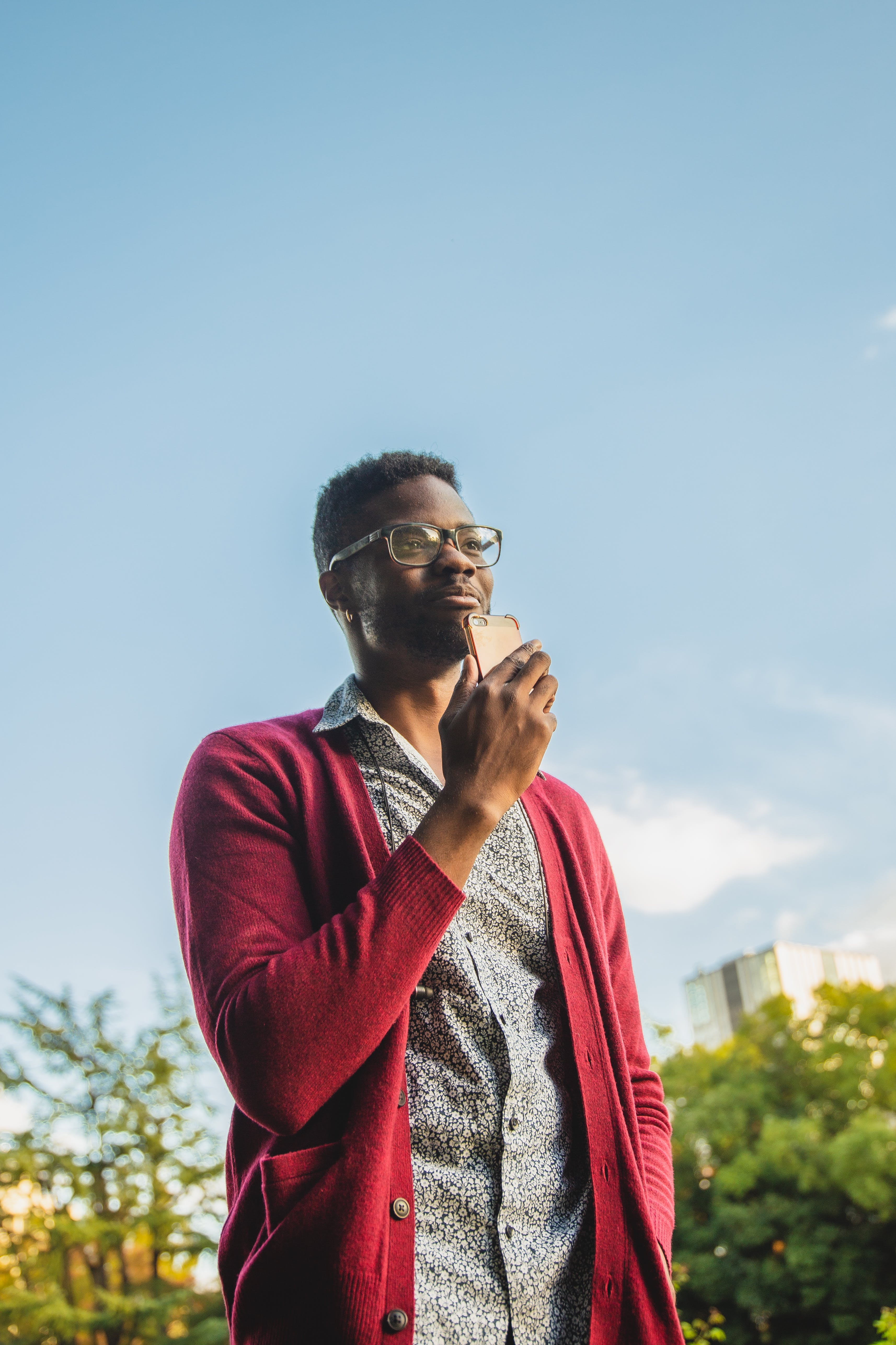 black man recording voice message on his phone 