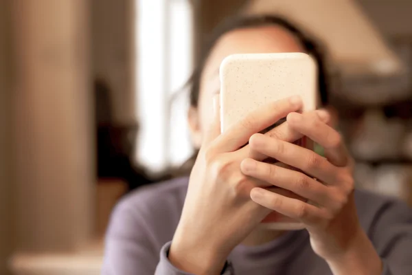 woman look ing at her phone