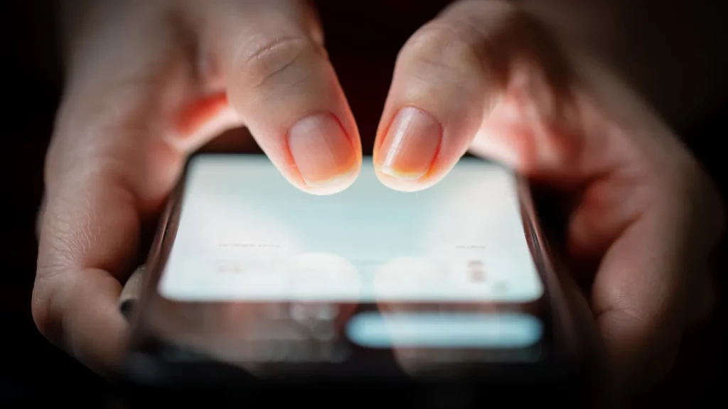 app user with hands on their phone